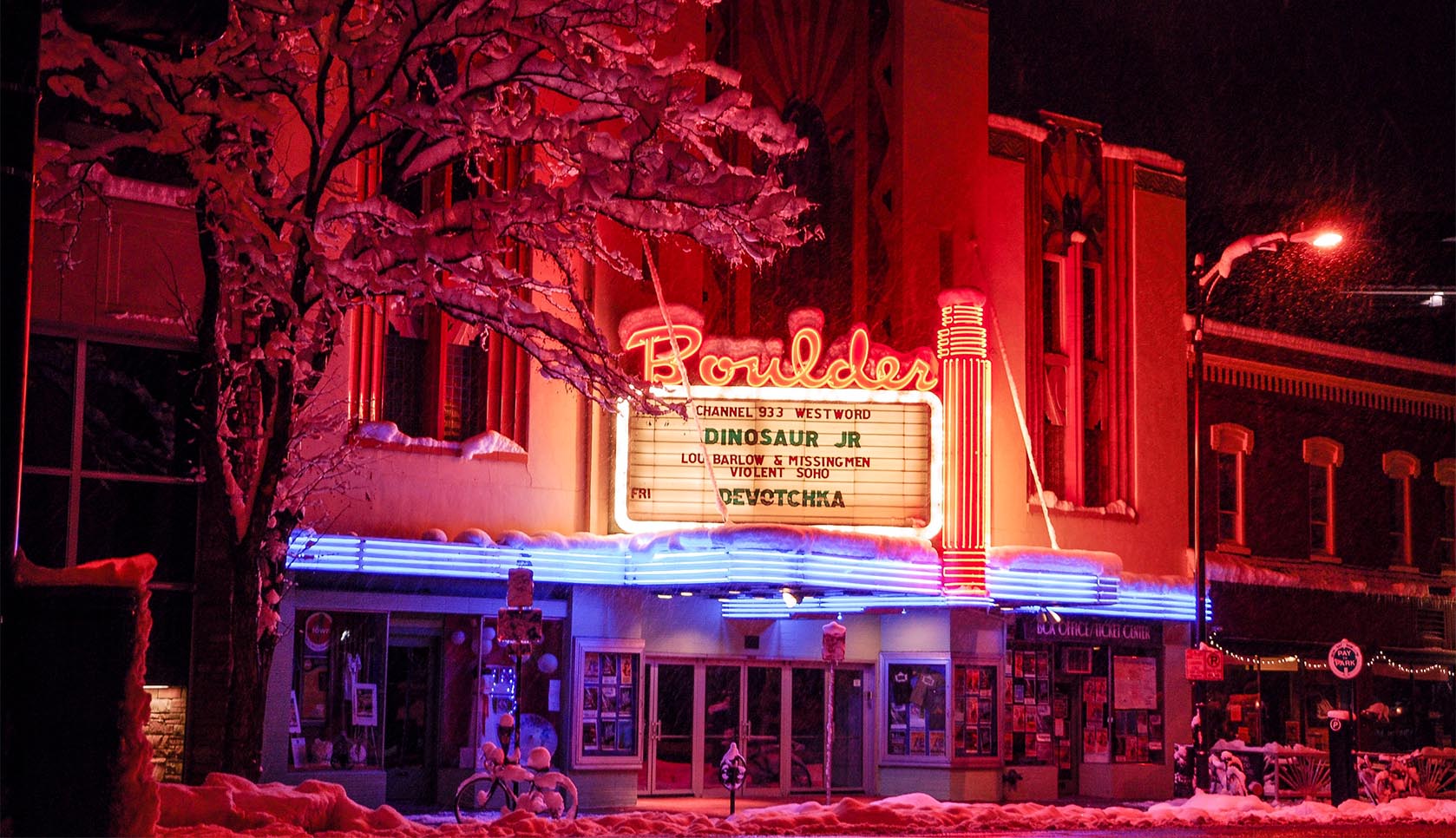 Boulder Theater facade lit brightly in the snow.