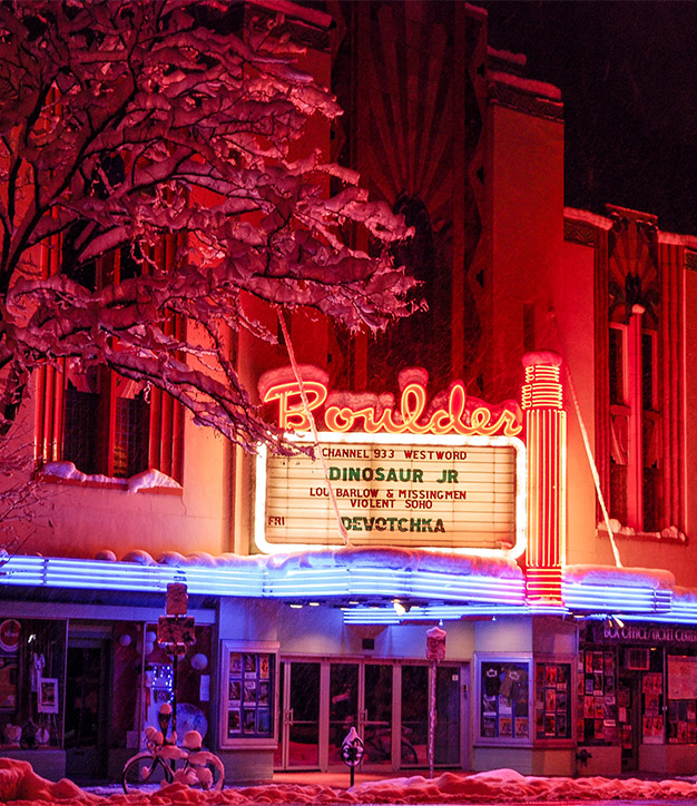 Boulder Theater facade lit brightly in the snow.