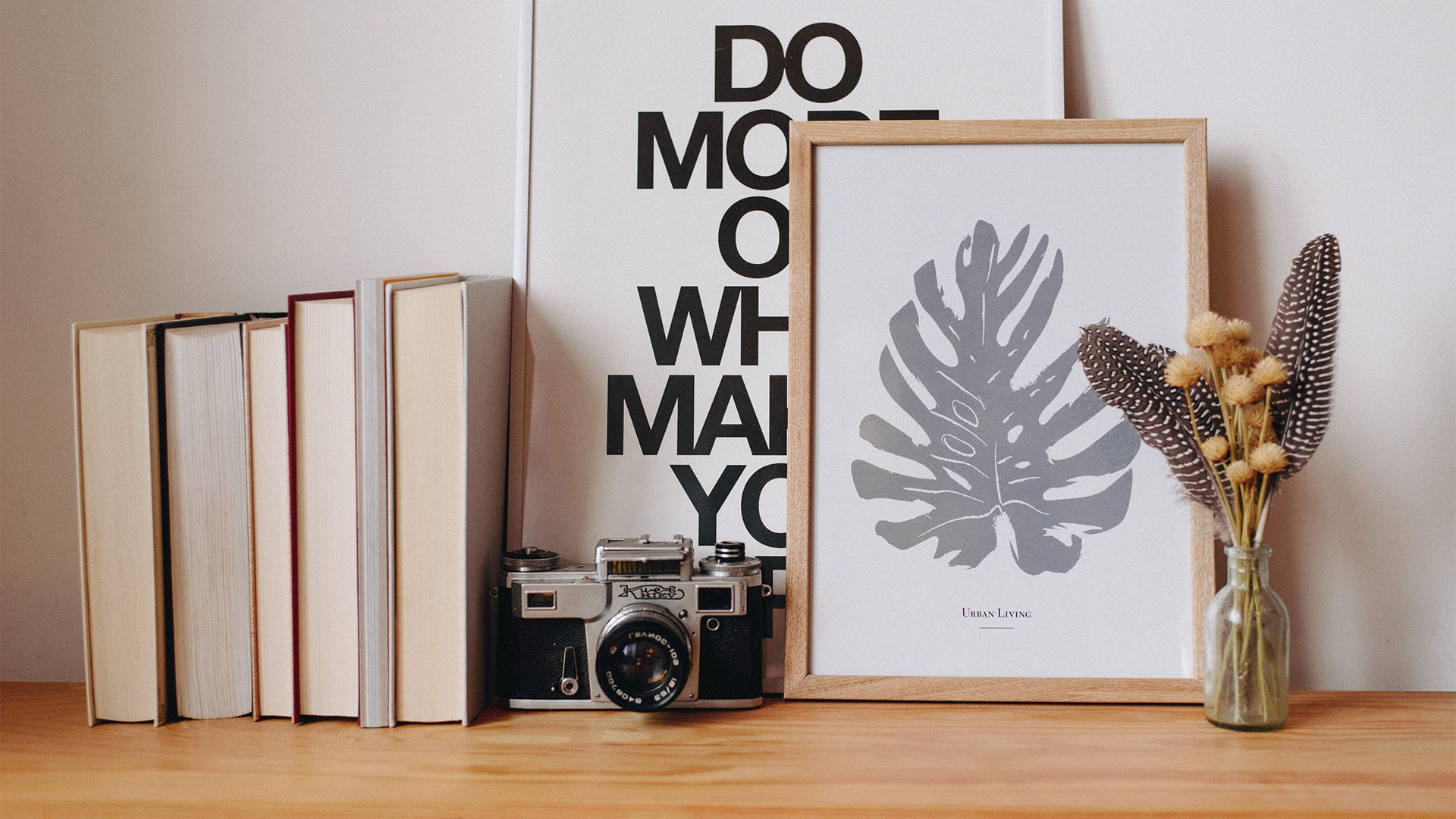 Shelf with books, decor, and vintage film camera.
